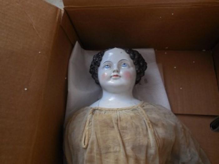 The china head doll has a kid body.  the face is unusual in that her eyes are gazing up.  She is a beautiful doll from 1860=80.