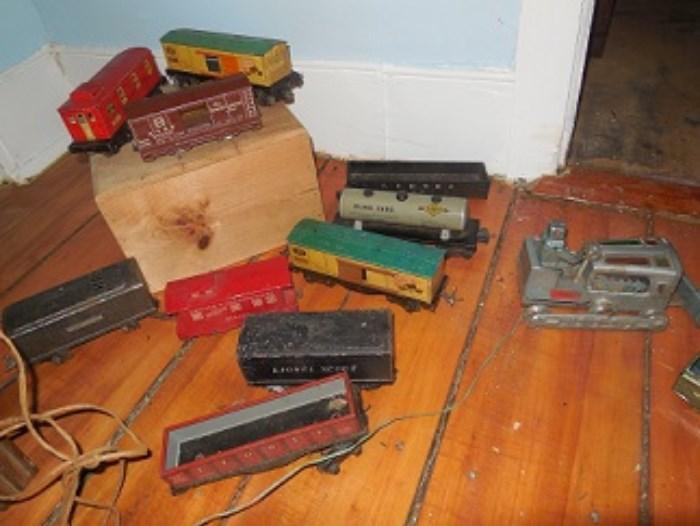 Lionel Train cars are pictured here.  There are two sets with track and accessories.  The bulldozer is remote control  Several other remote control cars are also in the sale. 
