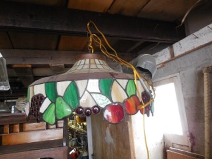 The lamp shade is in good condition and has fruit depicted in the edges. 