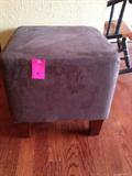One of a pair of suede ottomans