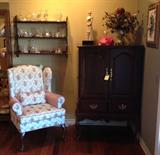 Lovely Queen Anne floral chair, crystal, and Hooker mahogany TV cabinet.