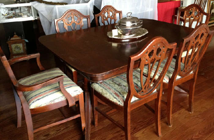 Antique mahogany Duncan Phyfe style table with six Sheraton shield back chairs, leaf and table pads