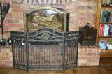 TWO VINTAGE FIREPLACE SCREENS ONE WROUGHT IRON & ONE BRASS WITH A SCENE ON IT