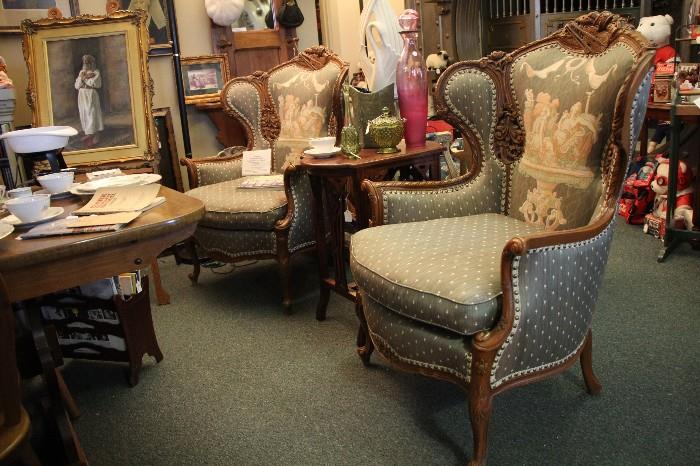 Deustch Bros. custom carved set of wing back chairs. 92+ years old. The carvings at the top of the chairs are of musical instruments.