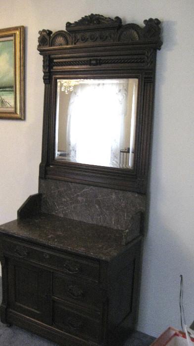 Smaller marble top dresser and ornate mirror.