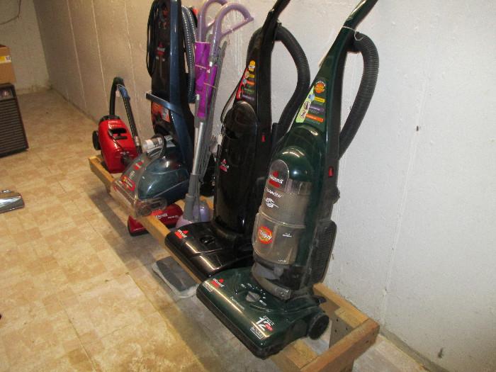 plenty of vacuum cleaners large and small