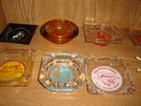 Nostalgic old advertising ashtrays from state and local businesses that are  no longer in operation.