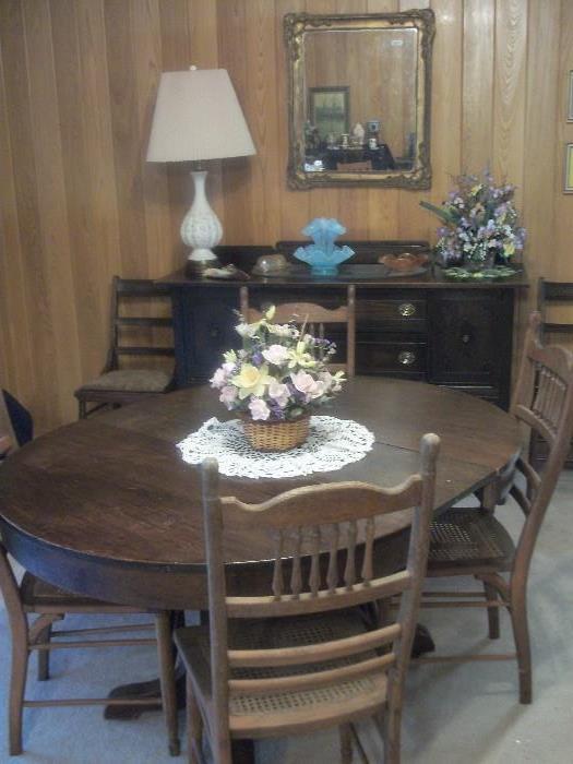 Oak center pedestal table w/leaf and four cane seat chairs