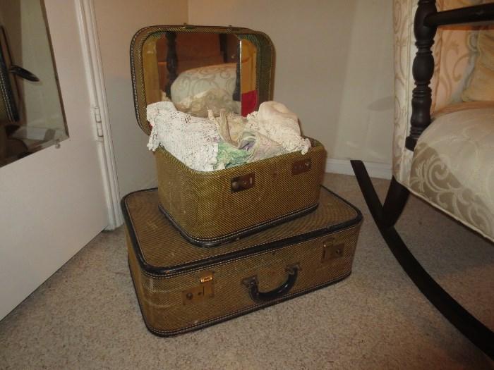 Love these old suitcases.  Top one filled with old doilies etc... 