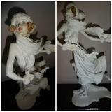 Another piece by Armani entitled "Iceskater." It is made of cast porcelain and hand painted depicting a woman in mid ice skate. It is 10" by 4.5" at the base and stands 15" high.