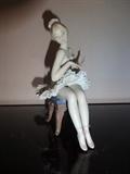 This hand painted porcelain piece depicts a Lladro ballerina sitting. It is 6.5" high by 5" long by 3" wide.