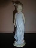 A 2002 piece by Lladro depicts a child with a butterfly in her hair and a few on her dress at the base. This hand painted porcelain piece stands 8" high by 3" long by 3" wide.