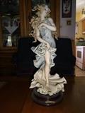 A depiction of a girl standing upon a clamshell by Giuseppe Armani circa 1992. Hand painted porcelain, it stands 14" high by 6" diameter.