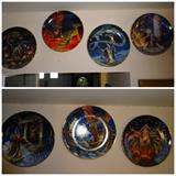 Photo 1 of 2: A set of 11 out of 12 collectors plates depicting sorcerers and dragons. They are 8.5" in diameter and show scenes of sorcerers and dragons interacting in various fantasy settings.