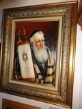An original oil painting by J. Straski entitled "Rabbi Holding Torah." It is in a gilded frame that is 24" by 20"