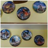 The Franklin Mint set of seven collectors plates from the "Indian Woman" plate series. They are 8" in diameter and depict Native American women in various mystical ways.