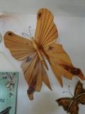 A large wood pink "Butterfly" hanging sculpture that is 25" by 18" and made of pine.