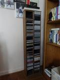 CD stand made of solid wood and plastic. It hold approximately 75 CDs and is 48" high by 12" wide and 6" deep.