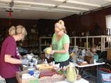 Rita and Carla cleaning the many pieces of ceramics and pottery in the sale. The loaded garage will open at 8:30 Thursday.