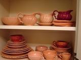 Franciscan ware in coral gloss (the dishes are pinker than they appear in this photo) and maroon gloss in the popular Coronado pattern 1936-1956, but most popular in the 1940's.