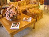 Pair of retro floral couches and ottomans