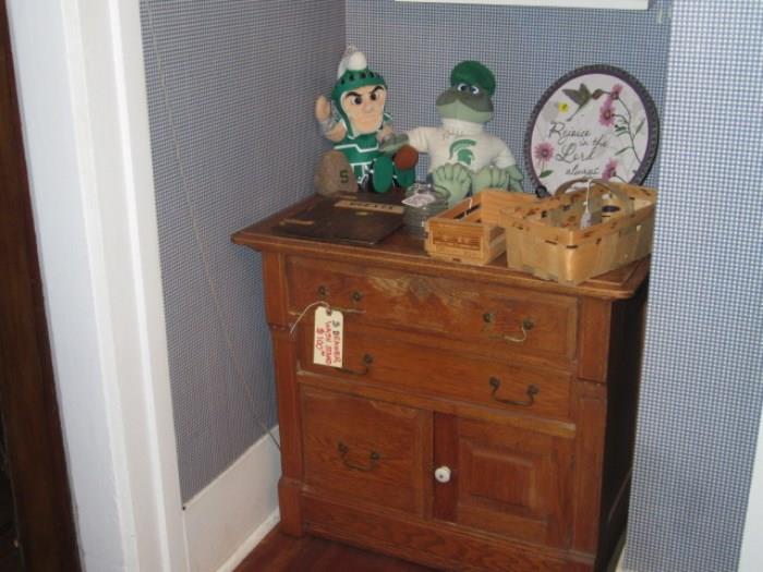 small cabinet and Sparty dolls.