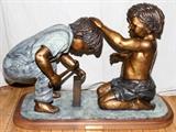 Lot#2100, DAVID GINZTON (1948-), BRONZE SCULPTURE, H 22", W 34", D 13", 'BEST FRIENDS'Of two boys, medium brown and antique green patina, mounted on a wood base with plaque revealing title and artist's name.  David Ginzton, American, born 1948.
