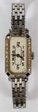 Lot#2112, ELEM WATCH CO. LADY'S DIAMOND, SAPPHIRE AND PLATINUM ART DECO WATCH, H 1.25", L .75"Marked Elem W Co.  Swiss 17 jewel.  The rectangular face is surrounded by twenty-two small round diamonds with sapphires at the four corners.  Interior of case marked 2 Platinum 3.