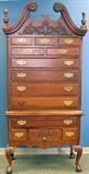 Lot#2120, MAHOGANY 13DRAWER HIGHBOY, H 81", L 41", D 19"The highboy is in two sections and has a swan-neck pediment with flower heads above a vine and leaf design with finials on each end.  The upper section has four full-length drawers below two half-length drawers and three smaller drawers.  The lower section has one full-length drawer above three drawers, the center drawer featuring a vine and leaf design with a lion form brass pull.  Cabriole leg with paw feet.