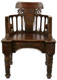 Lot#7, FRATERNAL CARVED OAK CHAIR, EARLY 20TH C//having a barrel back design with carved back splat with Greek letters and sun rays radiating from the center. Classical pillar form back frame supports. Carved front armrest supports depicting fraternal symbols and figures. Tapered turned legs with carved spiral vine and leaf designs. Front cross support having an arched bottom edge along with additional carved symbols and leaf designs.