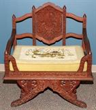 Lot#70, CHINESE CARVED ROSEWOOD ARM CHAIR, MID 20TH C, H 27", W 34", D 25"having an open contoured framework with detailed carved back rest and acanthus leaf designs throughout. Split 'V' style legs with carved floral designs. Needlepoint cushion signed "PRY" and dated "79".