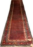 Lot#79, PERSIAN WOOL RUNNER, 17' 3" X 3' 11''having four borders, red ground with a red and brown repetition pattern.