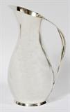 Lot#1001, TIFFANY & CO. STERLING WATER PITCHER, C. 1950, H 11 3/4"Elongated pear-form sterling silver pitcher, stamped at the underside "Tiffany & Co., Makers, Sterling Silver, 23380, M [Louis deBebian Moore, 1947-1956]" (see additional photo).  Weighs approximately 46.4 troy oz.