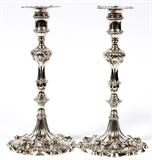 Lot#1005, GEORGE III STERLING CANDLESTICKS BY EBENEZER COKER, LONDON, 1762-63, PAIR, H 10 1/2"Each cast sterling silver candlestick has an inverted baluster stem raised on a lobed base adorned with shells and scrolls, with detached conforming nozzle.  Hallmarks at the underside of each candlestick include a lion passant, crowned leopard, date letter Gothic G, and maker's mark EC for Ebenezer Coker (see additional photo); one nozzle is stamped with a lion passant and maker's mark.  The base of each candlestick and the rim of each nozzle is engraved with a crest comprising a crown above a star and crescent within a laurel wreath.  Provenance: Purchased from J. H. Bourdon-Smith, Ltd., London, June 1988.  Totaling approximately 41.7 troy oz.