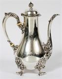 Lot#1008, HOWARD & CO. STERLING COFFEE POT, NEW YORK, C. 1900, H 9"Sterling silver coffee pot with hinged cover, scroll handle, and raised on four scroll feet, engraved script "M" at one side; stamped "Howard & Co., Sterling, New York" along with a rubbed number (see additional photo).  Weighs approximately 24.4 troy oz.