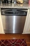 Maytag dishwasher, working, stainless interior.