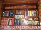 SOME OF THE MANY BOOKS. NOTE THE PANELING