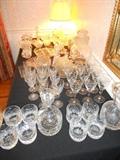 Crystal pressed cut glass, two Block decanters and glasses, many, many other pieces of everyday stemware in the kitchen cupboards, some monogrammed S.