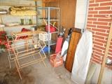 Garage full of assorted items, shelves, hall trees, vintage golf clubs, ice cream makers, 3 ironing boards, tools, etc....