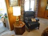 One of two leather recliners, several end tables, dozens of lamps, Lewisburg artwork