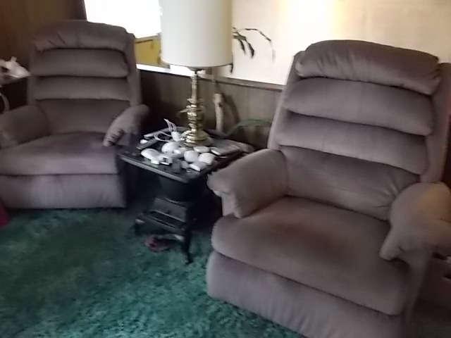 Pair of oversized recliners. Cast iron stove table.
