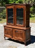 Lot 1168:  COUNTRY FRENCH CUPBOARD:  Carved crest over 2 glass front doors with 2 interior glass shelves.  Base with 2 doors, shaped front legs.  Overall 71" h. x 52 1/4" x 13 3/4".
