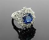 Lot 1044:  PLATINUM 7.57 Ct SAPPHIRE & 5.20 Ct DIAMOND RING: Outrageous sparkle in this platinum ring centering a 1.57 Ct sapphire of VS1 clarity and 4 saturation. Framing the sapphire are 10 old European cut diamonds and in the shaft are 14 early single cut diamonds all totaling approx. 5.20 Ct, averaging VS-SI clarity and H-K color. Size 6.5. Weight 15.8 grams. Sold with current Atlanta Gemological GIA graduate's appraisal for $35,450. Est. $11000/35000**