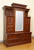 Lot 1018:  LATE VICTORIAN OAK MURPHY BED / ARMOIRE CABINET: In beautiful restored condition. The bed is self-stored and falls from the back. The front side with storage behind the mirror door and in the 8 drawers. May act as a room divider. Slides on casters. 79 1/2'' high x 58'' x 27 1/2''