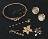 Lot 1050:  ESTATE ANTIQUE GOLD JEWELRY: 1) Opal and seed pearl hinged bangle bracelet, 2.5'' dia. 2) Flower form seed pearl watch pin, 1'' dia. 3) Pair sapphire and seed pearl lingerie pins. 4) Pearl and amethyst lavalier pendant, 1''L. 5) Black enamel decorated button earrings, 3/4'' dia. 6) Enameled stick pi. 14K gold weight 18.9 grams. 10K gold weight 8.1 grams.