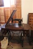 Treadle sewing machine with original accessories.