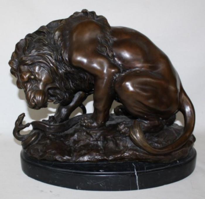 Bronze sculpture depicting lion and snake 