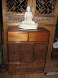 chinese chest. Behind chest is Ming period paired doors with panels which will slide up to close off pierced windows.
