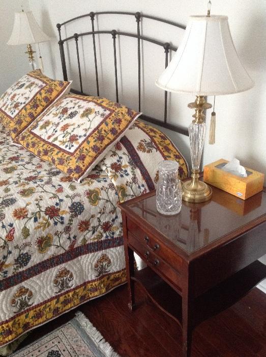 Iron Bed, Quilted Linens, Brass/ Glass Lamps. End Tables