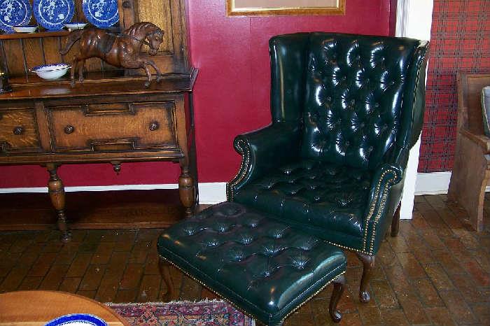 Wonderful dark hunter green leather (real) wing chair with ottoman, brass studs
